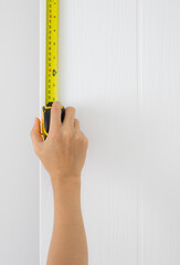Measure the door using a tape measure.