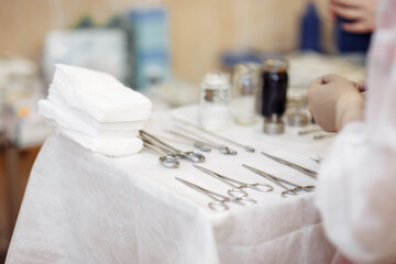 preparation of the operating table and surgical instruments by an assistant.