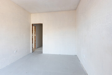 New empty room under construction. Plaster walls. New home. Concrete walls. Interior renovation.