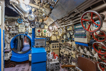 Fototapeta na wymiar Interior of old restored Russian Soviet submarine. Interior of combat submarine compartment with devices of control
