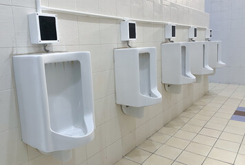 Men's white urinals design, Close up row of outdoor urinals men public toilet, Expulsion from the...