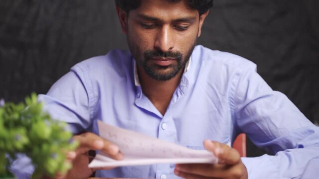 Close up of Young man got disappointed after reading mail paper letter - Concept of bad news, job termination, business deadline or eviction notice