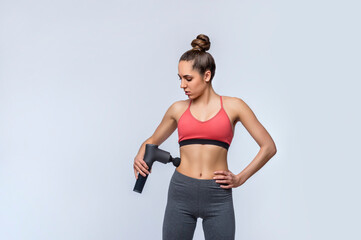 Electric massager gun in hand massages your muscles. Sport recovery concept