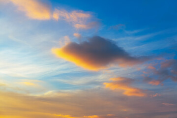 Naklejka na ściany i meble Vibrant sky background . Clouds in the soft evening light 