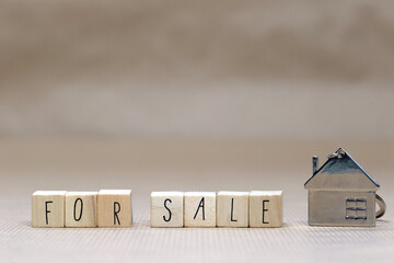 For sale written with wooden cubes, new house, real estate concept background,