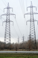 metal poles of power lines above the road