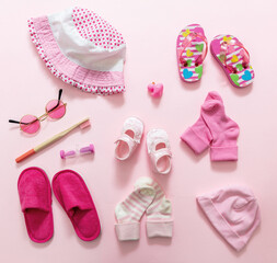 Baby girl accesories on pink background, baby shower concept