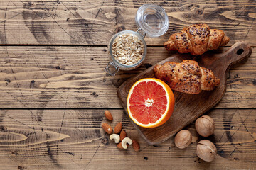 Healthy organic food: grapefruit, nuts, cereal, croissant