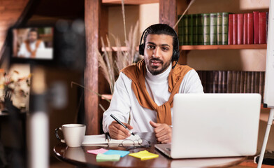 Modern Arab Teacher Man Recording Virtual Video Lecture Sitting Indoors