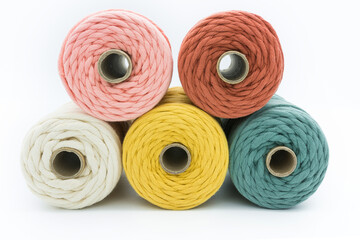 Close-up view of the colorful single strand cotton cords for macrame DIY handcraft on white background.
