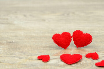 Big and small red love hearts on wood texture background