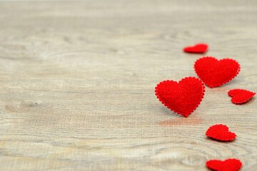 Fototapeta premium Big and small red love hearts on wood texture background