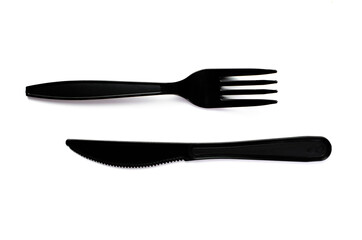 Black plastic cutlery knife fork spoon isolated on white background low highlight. For kitchen restaurant and table set up. concern to plastic conservative recycle items and one time use utensils