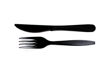 Black plastic cutlery knife fork spoon isolated on white background low highlight. For kitchen restaurant and table set up. concern to plastic conservative recycle items and one time use utensils