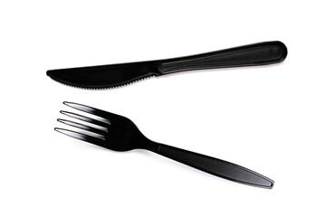 Black plastic cutlery knife fork spoon isolated on white background low highlight. For kitchen restaurant and table set up. concern to plastic conservative recycle items and one time use utensils