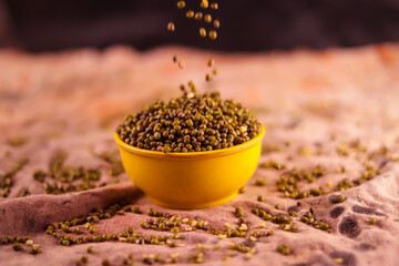 Whole moong-mung bean and wooden spoon heap,moong bean green gram or maash top view background,Pile of green bean