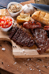 .Typical Brazilian barbecue, with garlic bread, picanha, sausage, vinaigrette and farofa