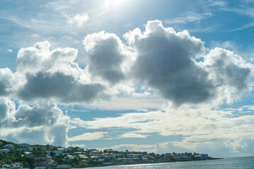 Naklejka na ściany i meble Blue cloudy skies during early morning sunrise. In the caribbean. 