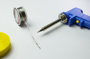 Man use blue color soldering iron to fix mainboard or motherboard chipset close up shot with other...