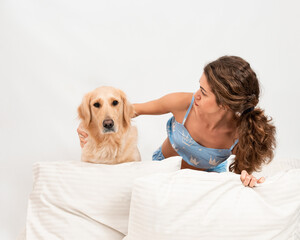 Cheerful Female woman sleep in pajamas lying in bed with her golden retriever dog. Romantic relationship human and dog concept