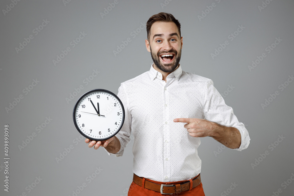 Wall mural excited funny young bearded business man 20s wearing classic white shirt standing pointing index fin