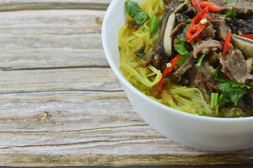 Beef soup with mee hoon or rice vermicelli or bee hoon with soy sauce.Basically called as Bihun Sup Daging.Processed flour mixed with turmeric. Beef soup that combine with internal organ of cows