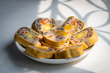 Mixed pork bologna roll with salted egg on green leaf decor asian food - Cha lua hoa