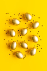 Golden Easter eggs with decoration. Top view