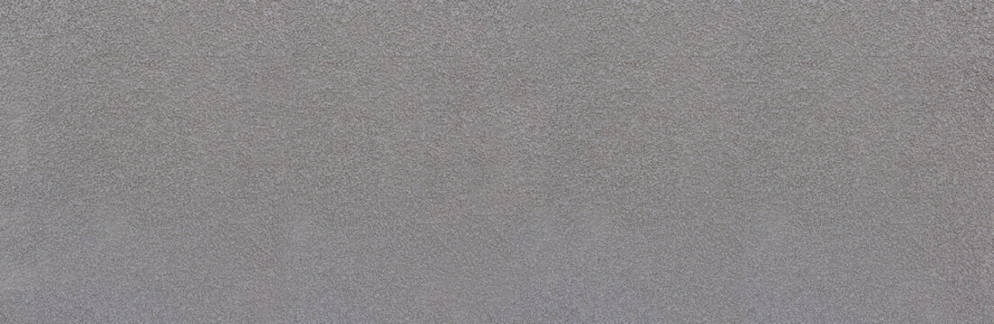 Grauer grober k&ouml;rniger Verputz mit vielen kleinen Steinen - architektonisches Detail, Panorama Hintergrund