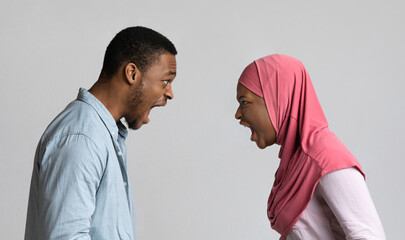 Angry black muslim couple yelling at each other