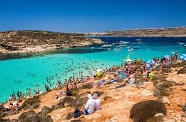 Overcrowded beach at blue lagoon in Comino island, Malta - obrazy, fototapety, plakaty