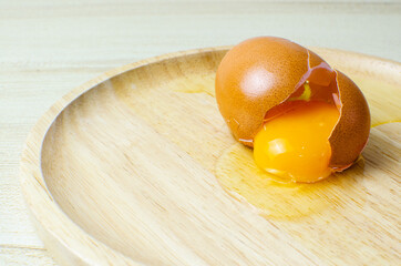 Eggs and broken egg on white background isolated wood table and wooden tray set up Food and beverage concepts
