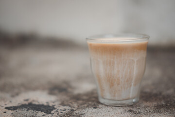 Coffee menu that is served separately between the cold fresh milk at the bottom of the glass and topped with espresso shot