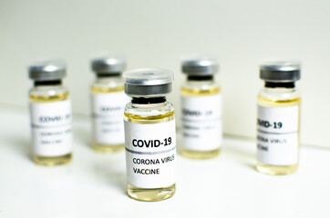 Covid-19 or Coronavirus vaccine in mini medicine bottles on white background, concern disease...