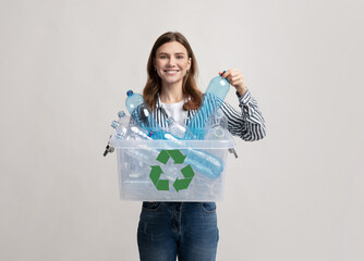 Waste For Recycling. Cheerful Young Woman Carrying Container Box With Plastic Bottles