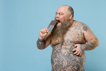 Crazy fat pudge obese chubby overweight man has tattooed naked big belly hold eating sweet...