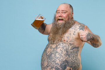 Side view of funny fat pudge obese chubby overweight man has tattooed naked bare big belly hold...