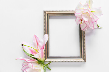 Beautiful lilies and frame on white background