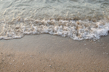 Sand beach and waves during sunset time for background and wallpaper