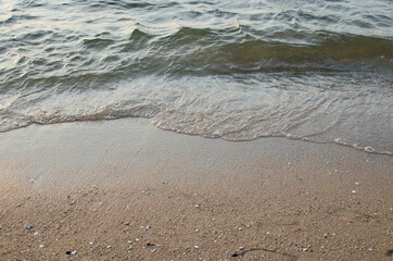 Sand beach and waves during sunset time for background and wallpaper