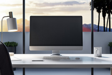 Modern desktop with empty black computer screen in office interior