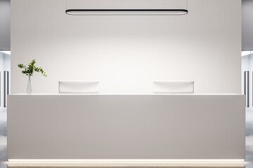 Obraz premium Modern office lobby with white reception desk, computers and blank wall.