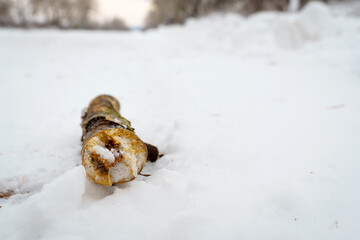 Obraz na płótnie Canvas Wooden log under the snow. Snowfall broke a tree