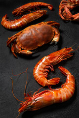assortiment de fruits de mer: araignée de mer, crabe et gambas sauvages sur le fond noir