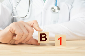 B1 alphabet on wood cube. doctor recommends taking vitamin b1. doctor talks about the benefits of...
