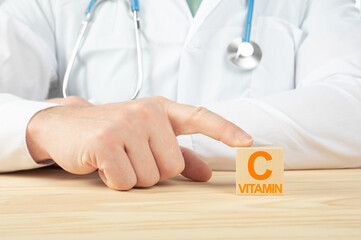 essential vitamins and minerals for humans. vitamin c alphabet on wood cube. doctor recommends...