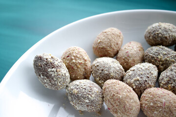 small home made easter chocolate eggs in a white dish