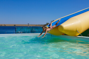 little girl jumping into the pool on a sunny day