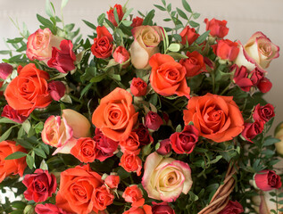 Bouquet of red, orange, yellow roses- a composition of multi-colored roses. Background for a postcard.