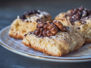 Homemade cookies with chunky nuts close-up on a white plate on a table
